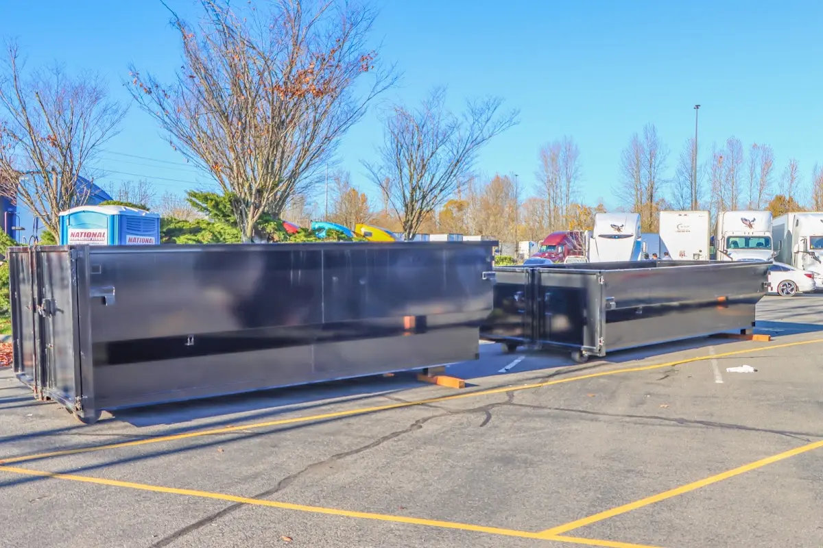 Professional dumpster rental service with roll-off container on residential driveway in Parlier